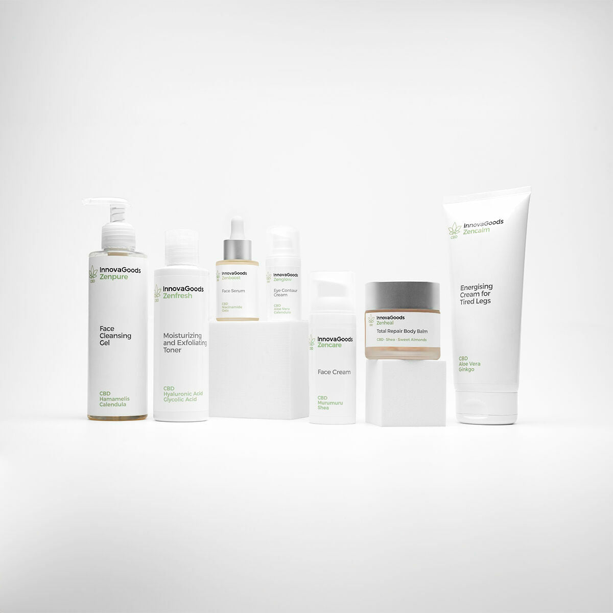 A collection shot displaying the balm alongside other InnovaGoods skincare products, all in varying packaging but with a cohesive, minimal design theme. The balm jar is prominently placed among taller bottles and tubes.