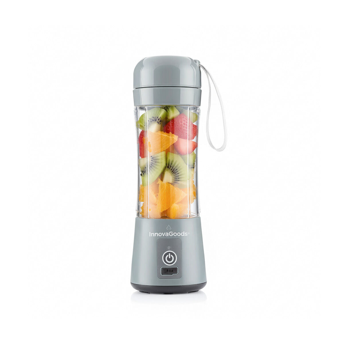 The blender filled with chopped fruits is positioned on a white background, emphasizing its clean, modern design and healthy living purpose.