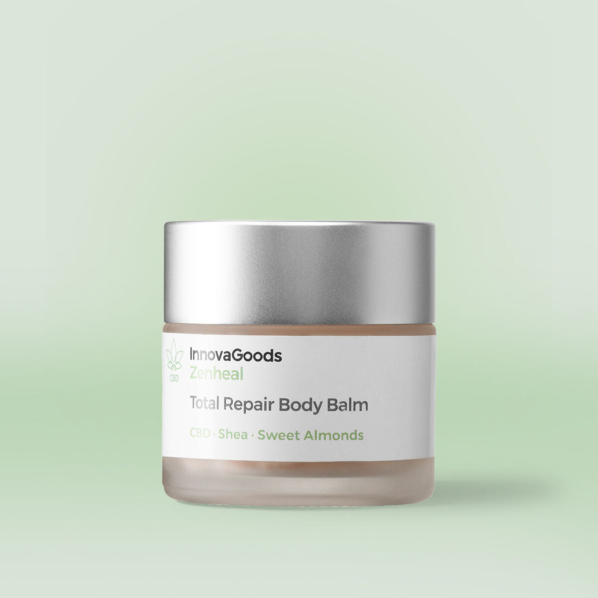 The balm is in a frosted glass jar with a matte silver lid. The label reads 'InnovaGoods Zenheal Total Repair Body Balm CBD · Shea · Sweet Almonds'. The background is a light pastel green, complementing the product's natural and soothing theme.