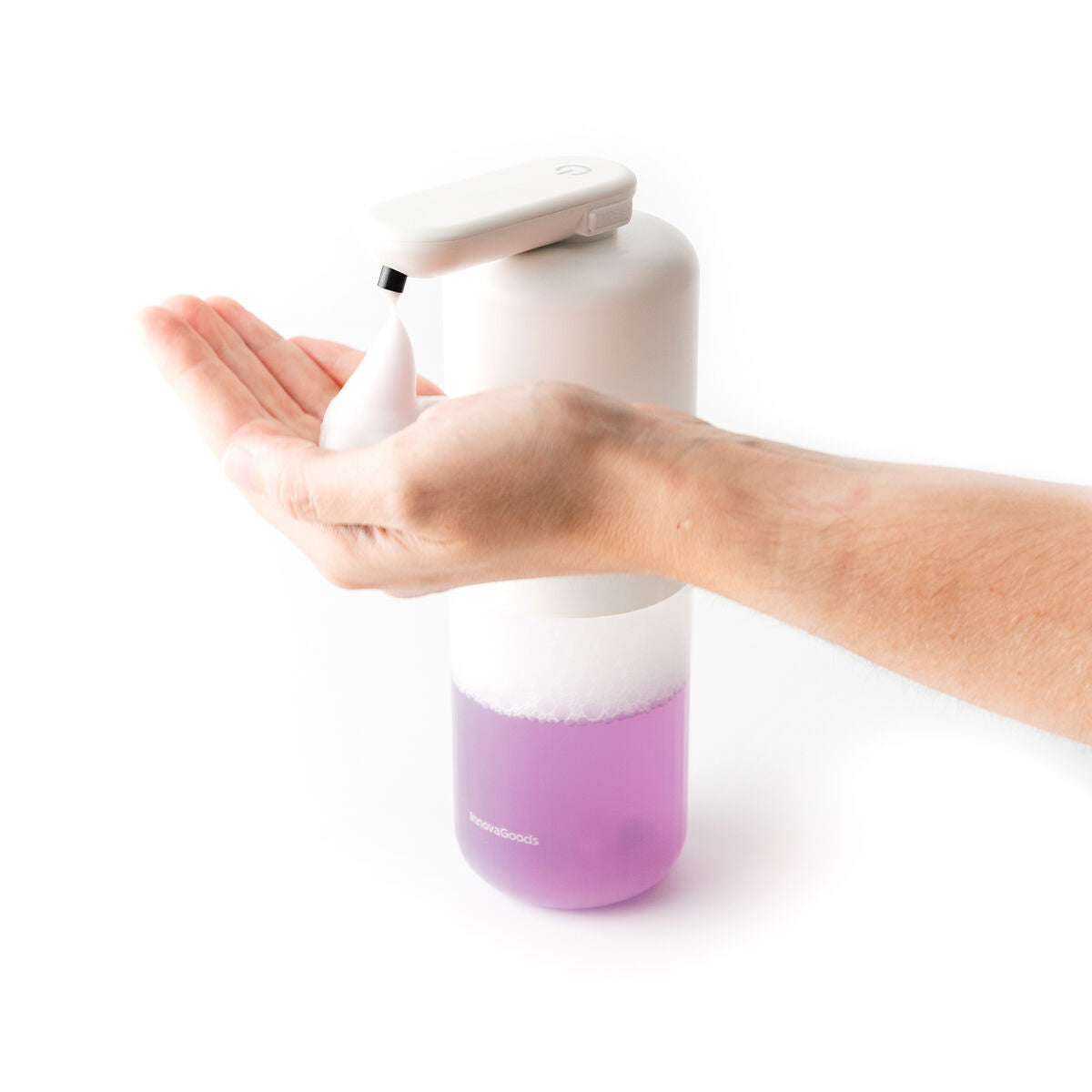 A hand is shown dispensing foam from the soap dispenser, with the purple soap visible in the transparent bottom section.