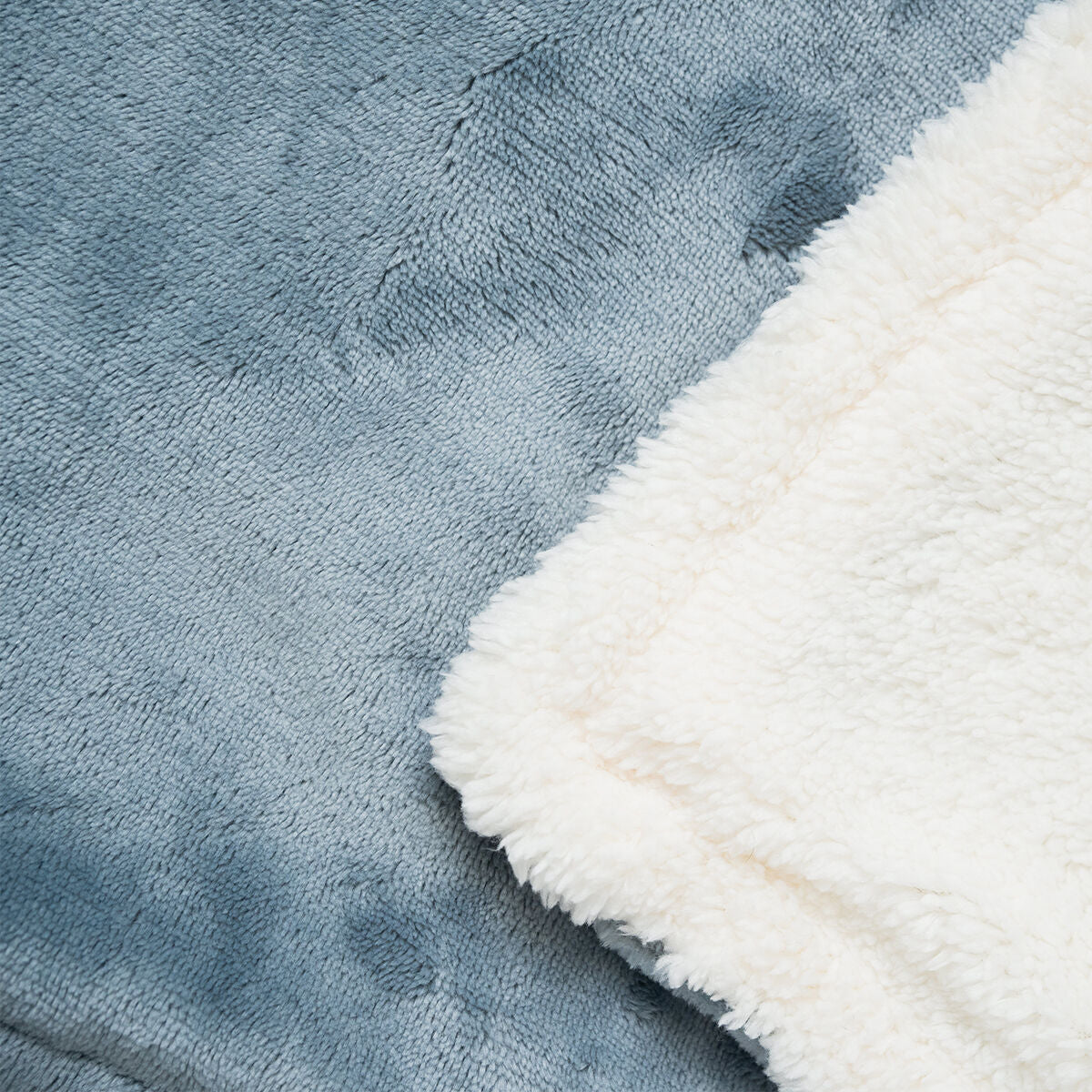 Close-up of the blanket's texture, showing the grey exterior and soft white interior.