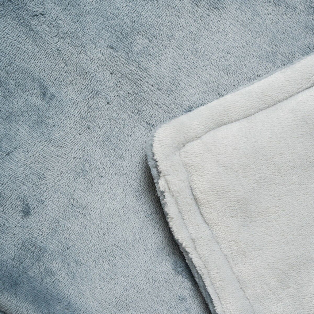 Close-up detailing the grey fleece texture of the blanket.