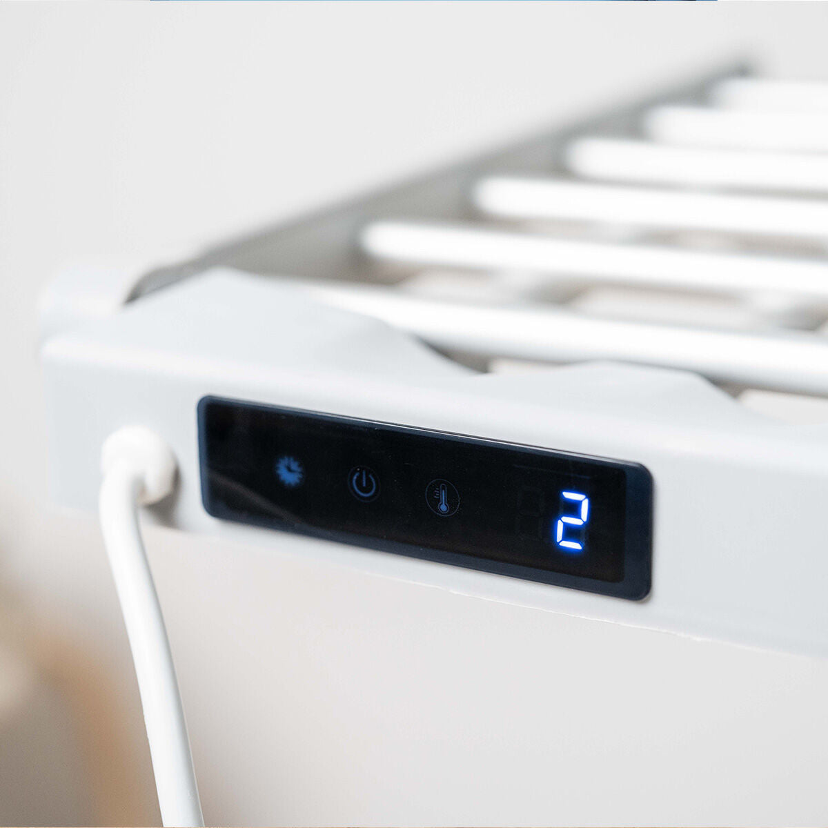 Close-up of the touch screen control panel, showing a digital display and buttons for power and temperature settings.