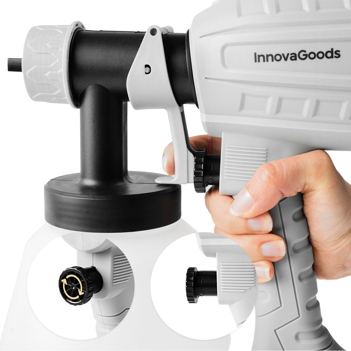 A close-up of the InnovaGoods paint sprayer being held, detailing the spray trigger and adjustable settings, emphasizing its ergonomic design.